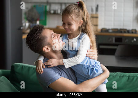 Happy smiling father holding on hands preschool daughter Stock Photo