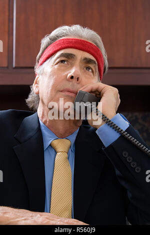 Businessman wearing a sweatband Stock Photo