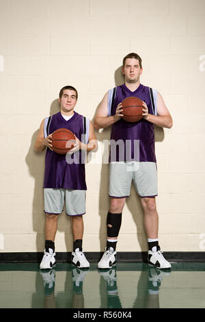 Tall and short basketball players Stock Photo