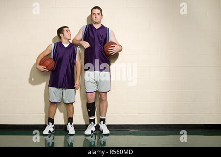 Tall and short basketball players Stock Photo