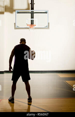 Man bouncing basketball Stock Photo