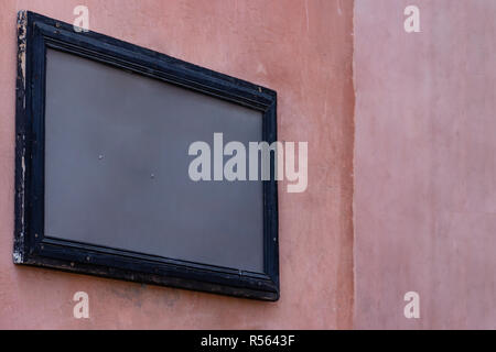 Empty mockup wooden painted frame gray template on pink grunge building wall for street advertisement. Modern startup promotion. Real texture. Stock Photo