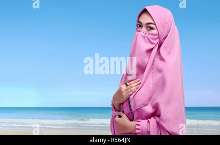 Portrait of asian muslim woman with niqab holding prayer beads Stock Photo