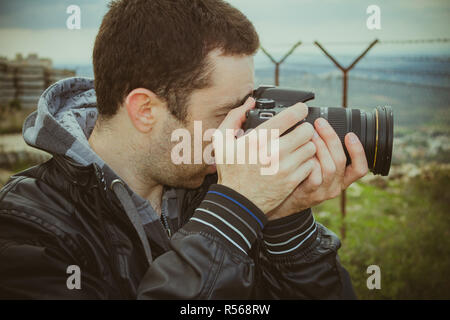 Photographer shooting outside with digital camera Stock Photo