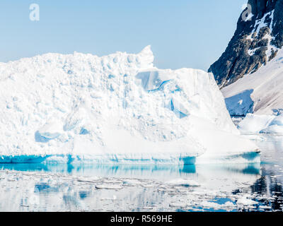 Small iceberg with calving ice and snow floating in Errera Channel, Antarctic Peninsula, Antarctica Stock Photo
