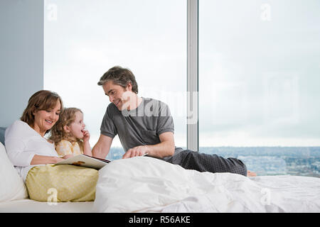 family reading a book Stock Photo