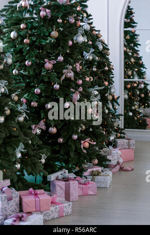 various gifts under beautiful Christmas trees Stock Photo