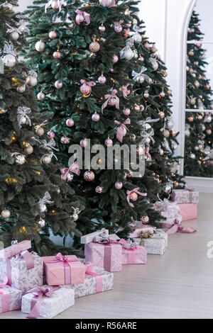 various gifts under beautiful Christmas trees Stock Photo