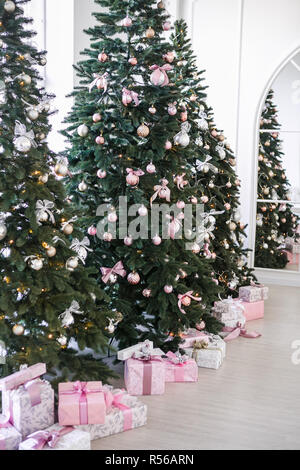 various gifts under beautiful Christmas trees Stock Photo