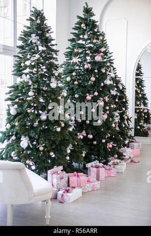 various gifts under beautiful Christmas trees Stock Photo