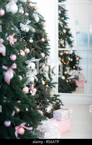 various gifts under beautiful Christmas trees Stock Photo