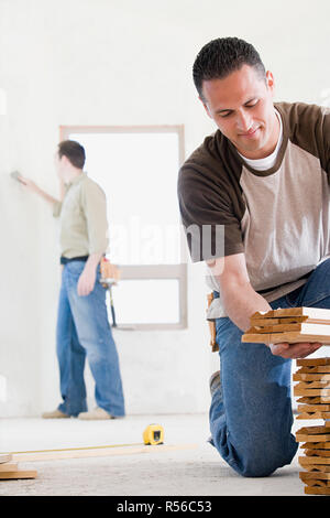 A man holding planks of wood Stock Photo