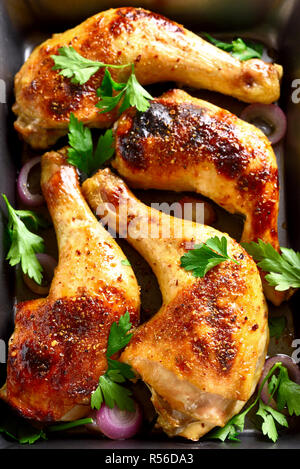 Close up of roasted chicken legs in pan. Top view Stock Photo
