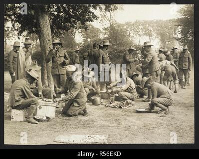 Gurkhas preparing and cooking food [St Floris, France]. Men of the 9th Gurkhas preparing food in the open air, 23rd July 1915. Record of the Indian Army in Europe during the First World War. 20th century, 23rd July 1915. Gelatin silver prints. Source: Photo 24/(65). Author: Girdwood, H. D. Stock Photo