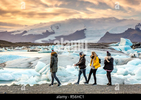 Jökulsárlón, Iceland - Nov 1st 2017 - Tourists and locals enjoying the Jökulsárlón iceberg lagoon with glacier in the background in Iceland