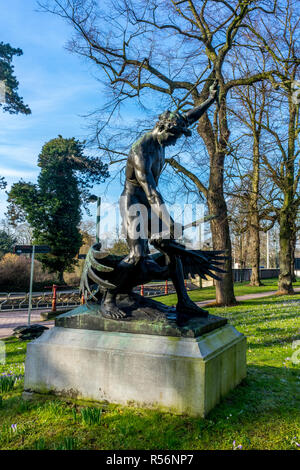Bruges, Belgium - 18 February 2018: statue of a person holding a bird by its beak at Brugge, Bruges, Belgium Stock Photo