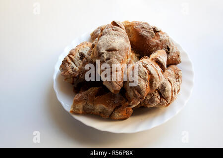 Freshly baked homemade croissants on plate isolated on white background Stock Photo
