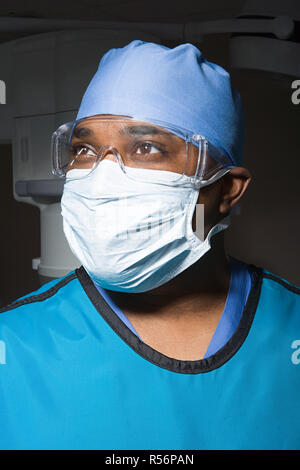 Surgeon in mask and safety goggles Stock Photo