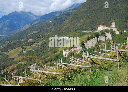 Panorama view on valleys and mountains in the italian alps, nearby Meran, South Tyrol, Italy. On the right the Castle Tyrol, in the middle the Brunnen Stock Photo
