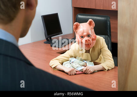 Businesswoman in pig mask holding money Stock Photo