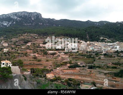 Aerial drone view of small hillside Banyalbufar town on west coast of Mallorca. Surrounded by Tramuntana mountain range. Spain Stock Photo