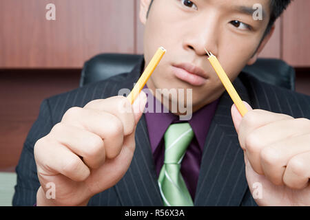 Businessman breaking pencil Stock Photo