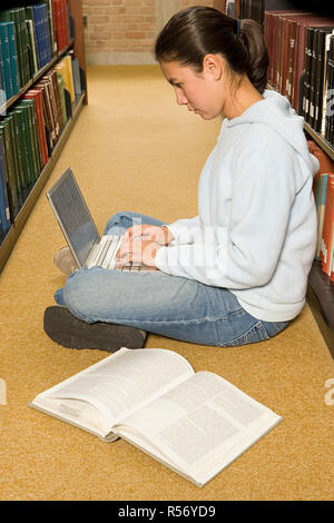 Female student studying in the library Stock Photo