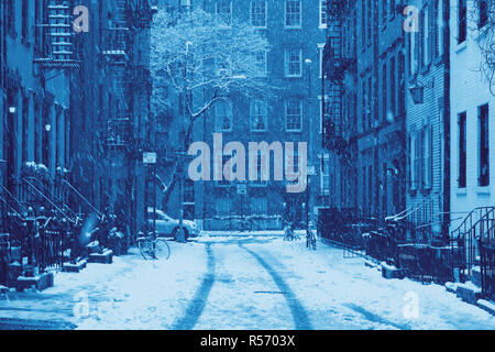 Snowy winter blizzard scene on Gay Street in the Greenwich Village neighborhood of New York City in blue Stock Photo