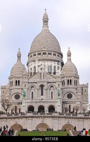 PARIS, FRANCE - JANUARY 05: Sacre Coeur Basilica in Paris on JANUARY 05, 2010. Tourists in Front of Basilica of the Sacred Heart of Jesus at Montmartr Stock Photo