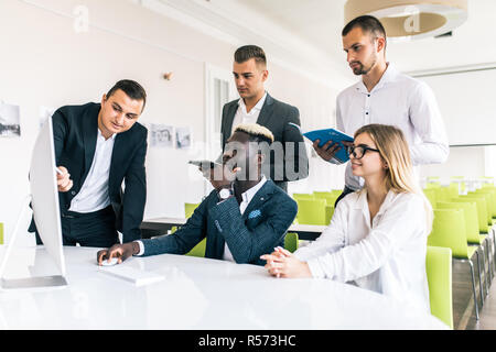 Young creative managers team working with new project in modern office. Stock Photo