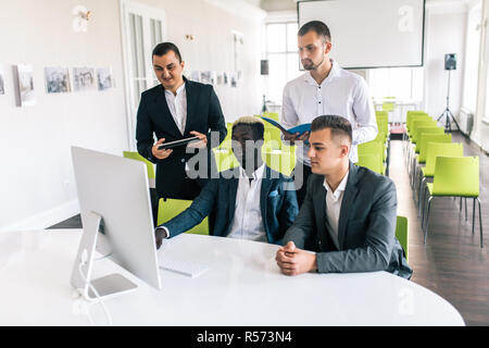 Young creative managers team working with new project in modern office. Stock Photo