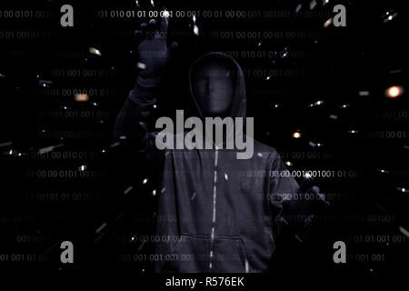 Hooded man with anonymous mask hacking binary system security code Stock Photo