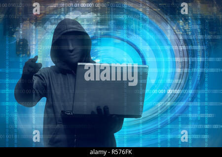 Hooded man with mask holding laptop Stock Photo