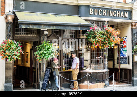 London England,UK,Westminster,Buckingham Arms Pub,traditional public house,exterior,roped al fresco outdoor drinking area,man woman,UK GB English Euro Stock Photo