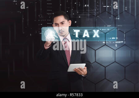 Handsome asian businessman with tablet computer touching Tax button Stock Photo