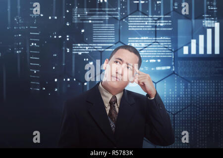 Confused asian businessman thinking something Stock Photo