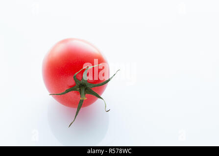 Juicy red tomato on a white background, close-up Stock Photo