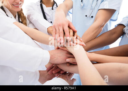 Group Of Doctors Stacking Their Hands Stock Photo