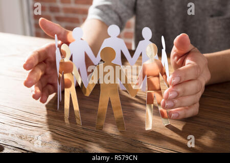 Person Protecting Paper Cut Out Figure Stock Photo