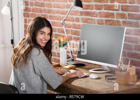 Smiling Woman At Workplace Stock Photo