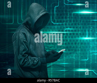 Hacker with mask touching a smartphone screen Stock Photo