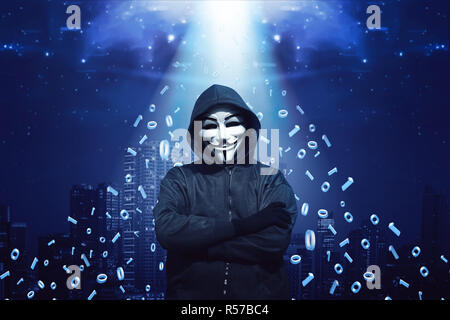 Hooded man with mask standing Stock Photo