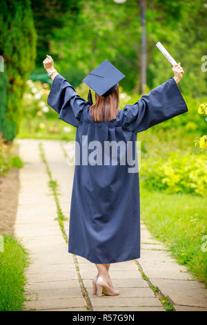 Young woman graduation day images of graduates are celebrating graduation put hand up Stock Photo