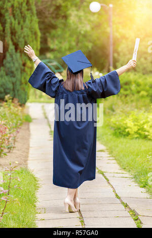 Young woman graduation day images of graduates are celebrating graduation put hands up Stock Photo