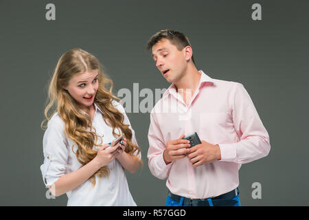 Business concept. The two young colleagues holding mobile phones on gray background Stock Photo