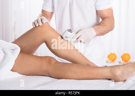 Woman Having Laser Treatment At Beauty Clinic Stock Photo