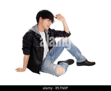 Young Asian man sitting on floor. Stock Photo