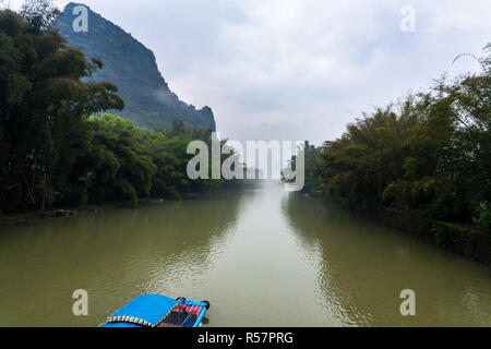 chinese boat on river near peaks near Xingping Stock Photo