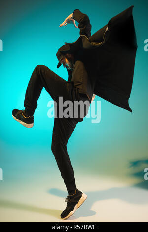 The silhouette of one hip hop male break dancer dancing on colorful background Stock Photo