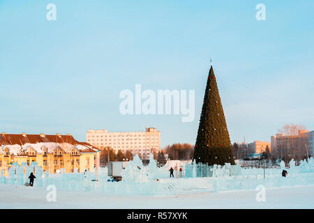 Workers build an ice town and decorate a Christmas tree before the New Year Stock Photo